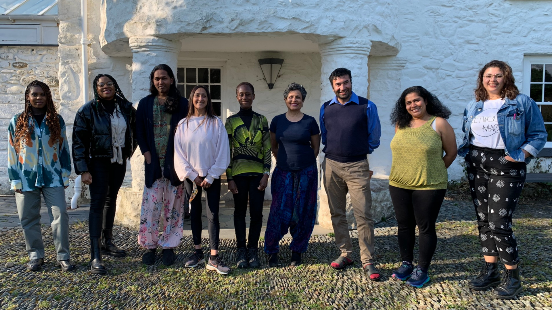 Books for All cohort standing in front of Tŷ Newydd Writing Centre.