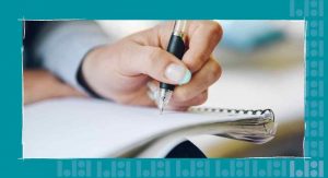A person writing with pen and paper